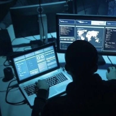 Someone using a computer in a dark room